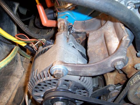 1983 Ford Bronco - Close-up view of an alternator and associated engine parts, likely from a Ford vehicle.