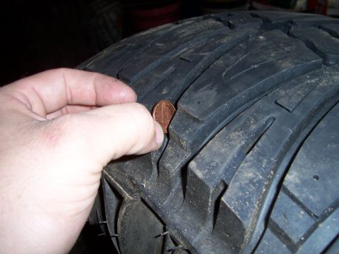 1983 Ford Bronco - Penny inserted into tire tread to demonstrate depth.