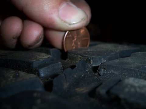 1983 Ford Bronco - Checking tire tread depth with a penny.