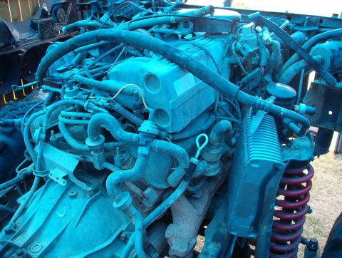 1994 Ford Bronco - Close-up view of a vehicle's engine compartment, showing complex plumbing and mechanical components.