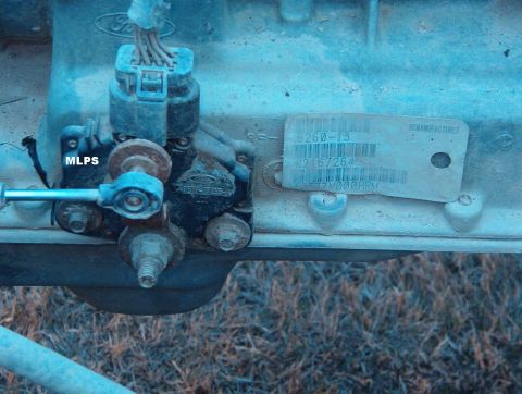 1994 Ford Bronco - Close-up of a remanufactured part with a label and MLPS sensor.