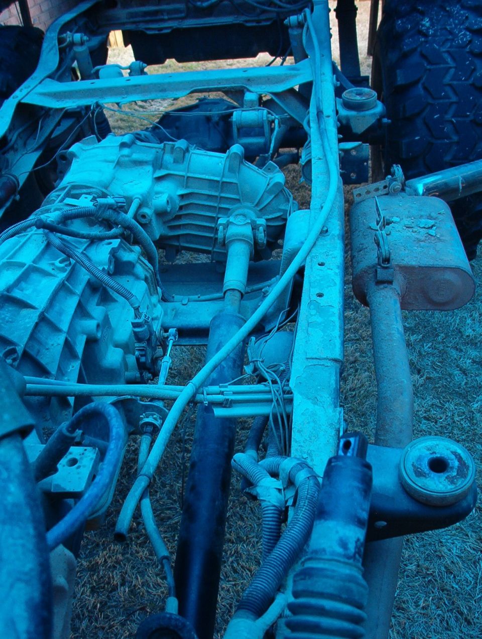 The rear axle vent line was run all the way to the shifter cable. Why? We may never know. The end is lower than the frame over the axle, so it's MORE likely to suck water here than if it had been left stock. It's also facing straight forward, with no vent cap to keep water or insects out.