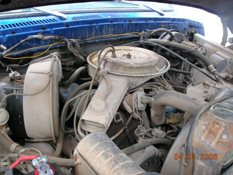 1985 Ford Bronco - The engine bay of a vehicle, showing the air cleaner assembly, hoses, and wiring. A date stamp indicates the photo was taken on April 3, 20…