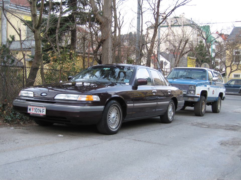 Dark brown 1992 Ford Crown Victoria, front 3/4 view, parked on street. License plate W 1014 F