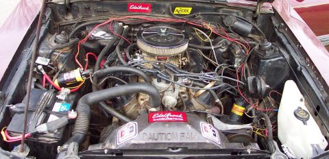 1985 Ford LTD Crown Victoria - Engine bay details with aftermarket performance parts visible, including Edelbrock and Accel branding.