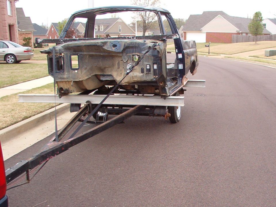 The pipe thru the windshield is for the come-along that's holding up the trailer's front axle.  Long story...