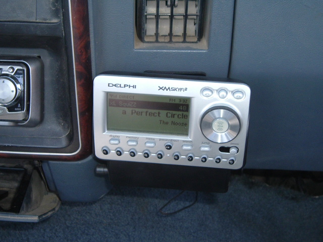 Delphi XM SkyFi2 satellite radio receiver mounted on woodgrain dash of an older truck