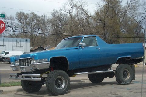 1972 Ford Ranchero - This heavily modified Cadillac pickup truck features a lifted suspension and oversized tires, giving it a unique, appearance.