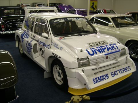 2002 Ford Focus - Austin Metro 6R4 rally car with extensive aerodynamic modifications and sponsor decals.