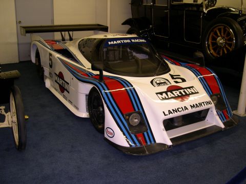 2002 Ford Focus - A Lancia Martini racing car is displayed indoors, with another vintage car visible in the background.