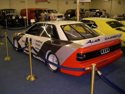 2002 Ford Focus - A white, brown, and orange Audi Quattro race car is displayed indoors with other vehicles.