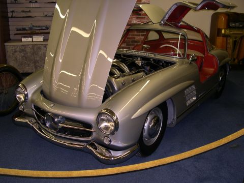2002 Ford Focus - This classic gullwing coupe, likely from the 1950s, is displayed with its hood and doors open, revealing its engine and red interior.