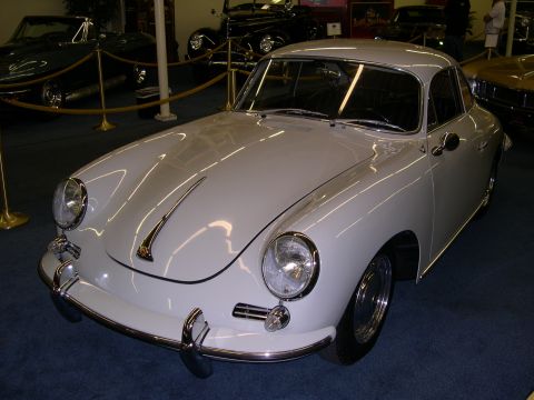2002 Ford Focus - A classic white Porsche 356 coupe is displayed indoors, with other vintage vehicles in the background.