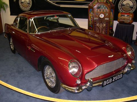 2002 Ford Focus - A shiny red classic coupe is displayed indoors with vintage decor in the background.