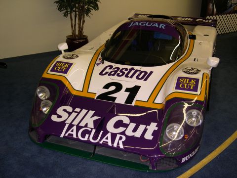 2002 Ford Focus - A race car with prominent "Silk Cut" and "Jaguar" branding is displayed indoors.