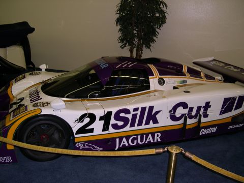 2002 Ford Focus - A Jaguar Silk Cut race car is displayed indoors, prominent branding and racing numbers.