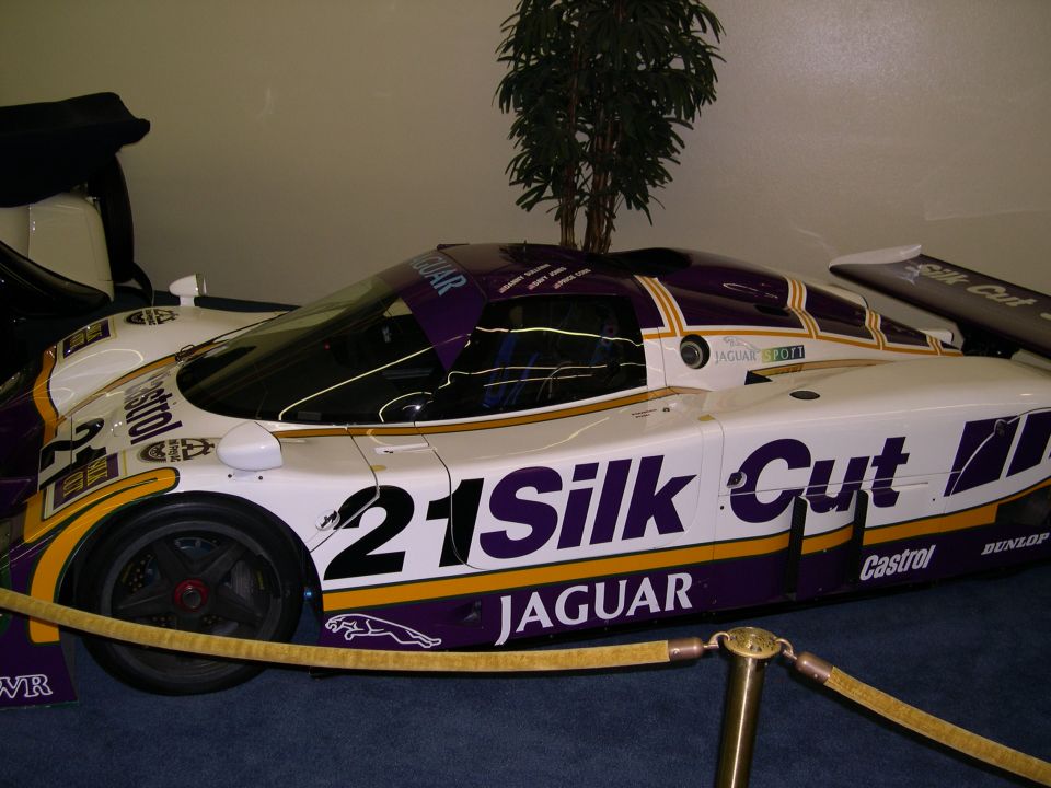 White and purple Jaguar Silk Cut race car with number 21, side view