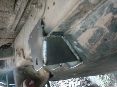 1978 Ford Bronco - Close-up of a welded bracket on a vehicle's frame, indicating custom work.