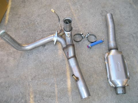 1993 Ford Bronco - Aftermarket exhaust components laid out on a concrete surface.