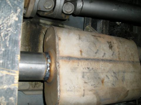 1993 Ford Bronco - Close-up of a Flowmaster exhaust muffler, showing its markings and a Supermotors.net watermark.