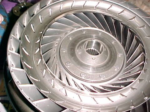 1997 Ford Taurus - A silver torque converter with a splined central hub is shown in a close-up view.