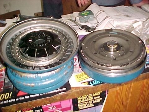 1997 Ford Taurus - A torque converter and flexplate are displayed on a table, likely for automotive repair or sale.