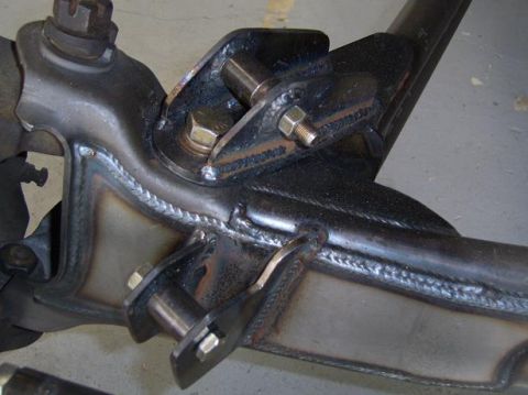 1984 Ford Bronco - Custom fabricated suspension components with visible welding seams and bolted connections.