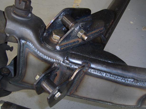 Close-up of custom-welded suspension parts, likely for a truck or SUV