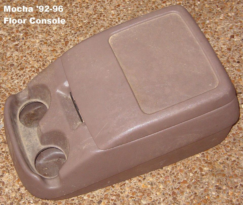 Mocha-brown center floor console with dual cupholders and lid, labeled 92-96