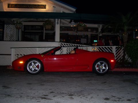 1994 Ford Probe - A red convertible sports car is parked outside a building with "E.R. Bradley's Saloon" visible.