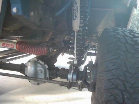 1978 Ford Bronco - Close-up view of the suspension and drivetrain components of an off-road vehicle.
