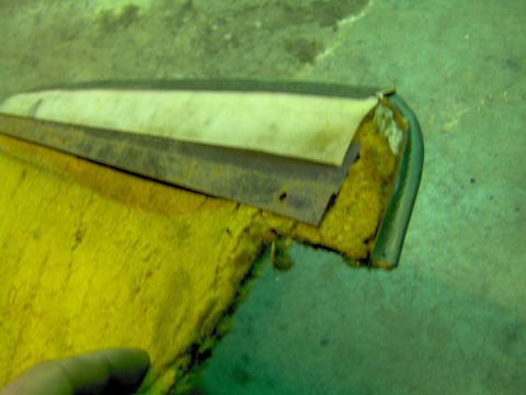 1979 Ford Bronco - Close-up of a worn interior door panel, showing yellow upholstery and exposed metal components.