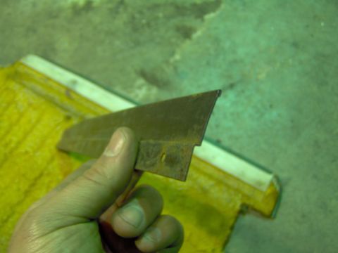 1979 Ford Bronco - A close-up shows a person holding a weathered metal trim piece, possibly a car part.