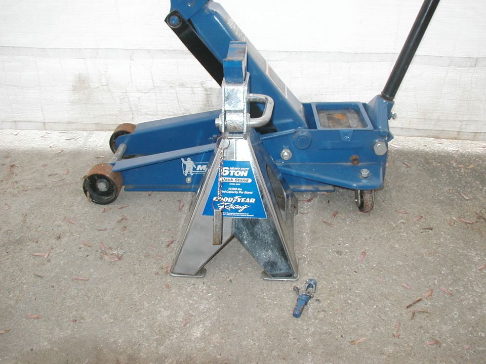 Silver Goodyear 6-ton jack stand in front of a blue Michelin floor jack on concrete