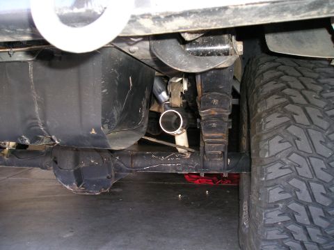 1993 Ford Bronco - Close-up view of the undercarriage, focusing on the exhaust system and rear axle components.