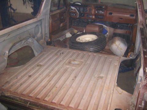 1978 Ford Bronco - The interior of a 1978 Ford Bronco, viewed from the rear cargo area towards the dashboard.