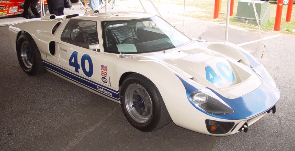 White Ford GT40 Mk II race car with blue number 40 graphics displayed under a canopy