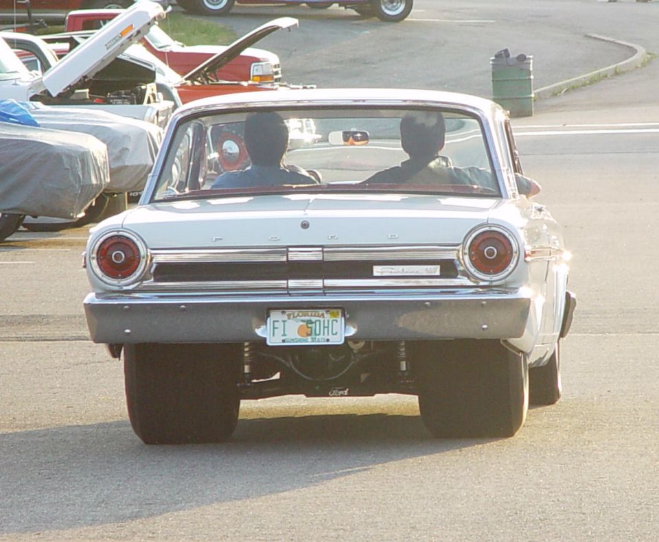Rear of white 1960s Ford sedan with Florida plate and round taillights