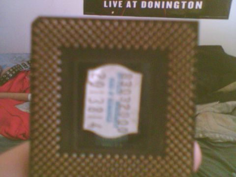 1985 Ford F-150 - A computer chip is shown in detail, with a sticker bearing some numbers and text.