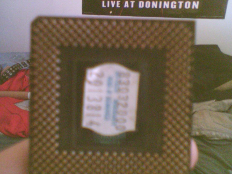 Close-up of a computer chip with a sticker on it. Text on sticker is partially visible