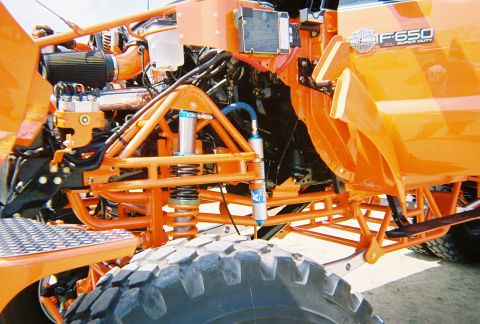 1989 Ford F-350 - Custom orange Ford F-650 Super Duty with heavy-duty suspension components and off-road tire.