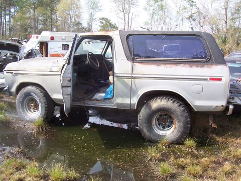 1978 Ford Bronco - This 1978 Ford Bronco sits in a junkyard with its driver's door ajar.