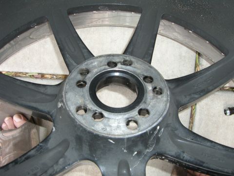 1996 Ford Probe - A close-up view of a black alloy wheel, focusing on the central hub and the design of its spokes.