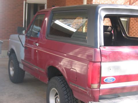 1991 Ford Bronco - This Ford Bronco shows a mix of red and gray body panels, indicating recent bodywork or repairs.