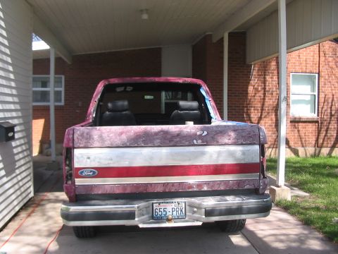 1991 Ford Bronco - Rear view of a 1991 Ford Bronco, parked under a carport.