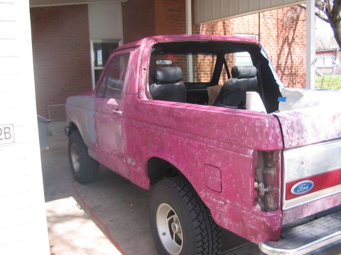 1991 Ford Bronco - This 1991 Ford Bronco is undergoing bodywork, with primer visible and some parts removed.