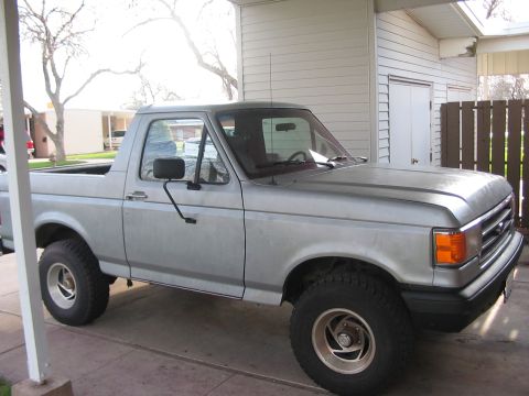 1991 Ford Bronco - This silver pickup truck appears to be a 1992 model based on its grille design.