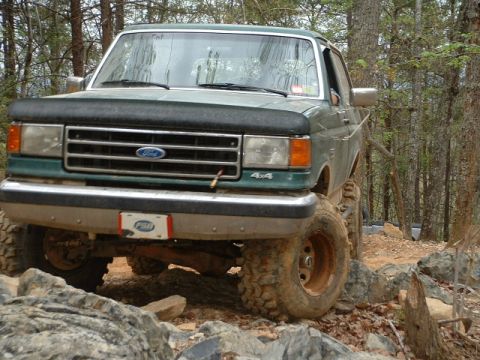 1987 Ford F-150 - This 1987 Ford F-150 is navigating a rocky trail in a wooded area.