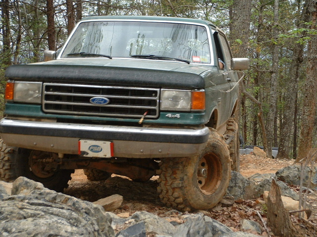 Green 1987 Ford F-150 on rocky terrain