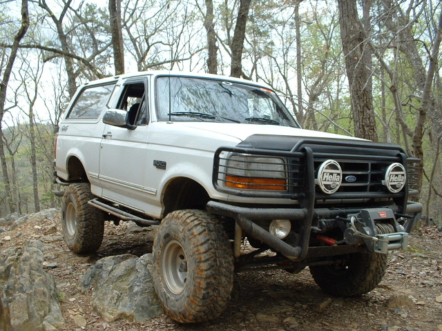 White Ford Bronco with off-road tires and winch